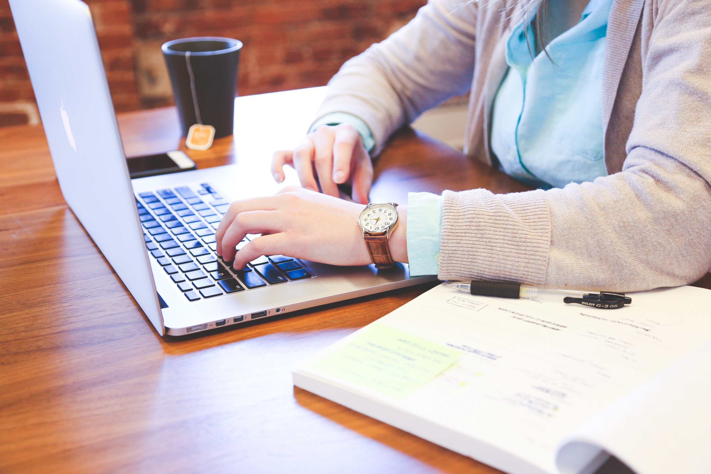 Student works at laptop in a coffee shop