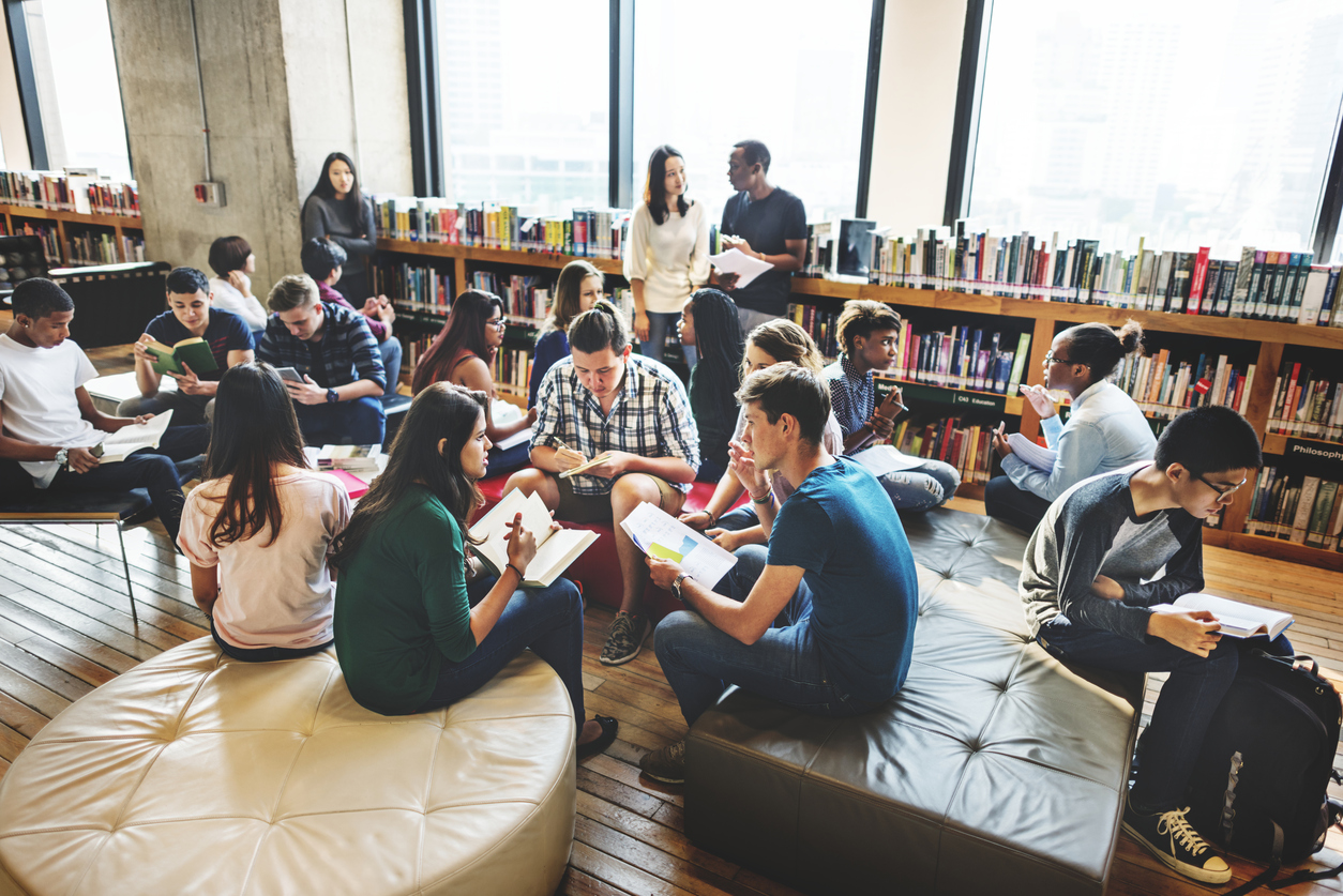 Group of students in a library or common room, chatting